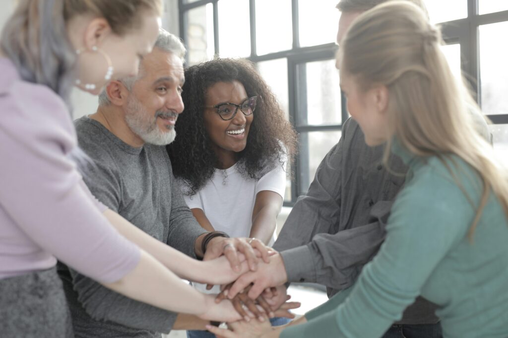 a group of people in a circle laughing illustrating Body Language in Requirements Engineering