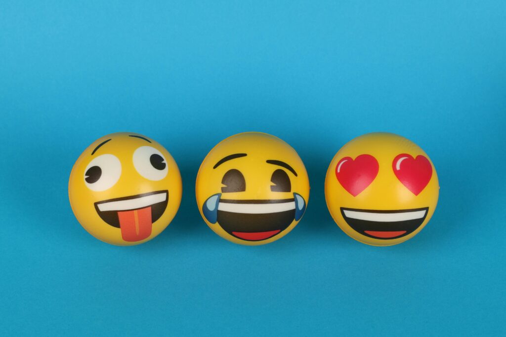 three emojis, one looking crazy, one laughing and crying and one with hearts as eyes demonstrating Understanding Users with Personas