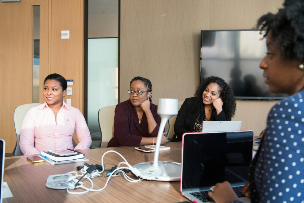 a group of business women listening to a presentation illustrating presentation as a requirements engineer
