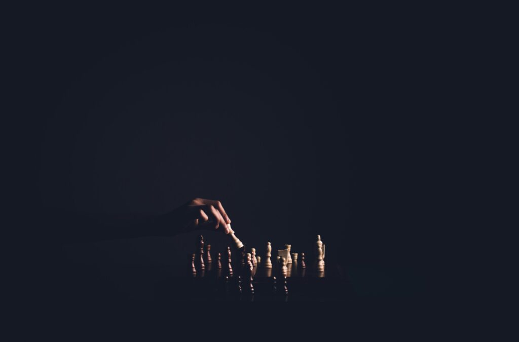 a chess board and a hand moving the figures illustrating Personality Traits in Requirements Engineering