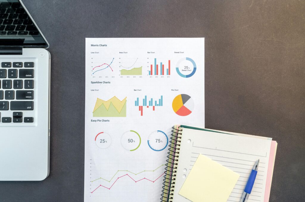 A paper with charts and a notebook on a desk for Systematic Identification of Stakeholders