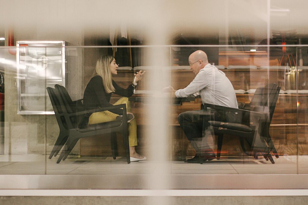 a woman and a man talking and illustrating problem solutions in requirements engineering