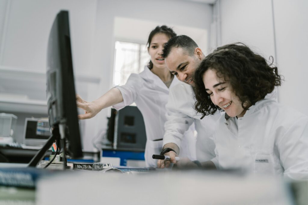 Three people at a computer illustrate why eliciting requirements is similar to doing research