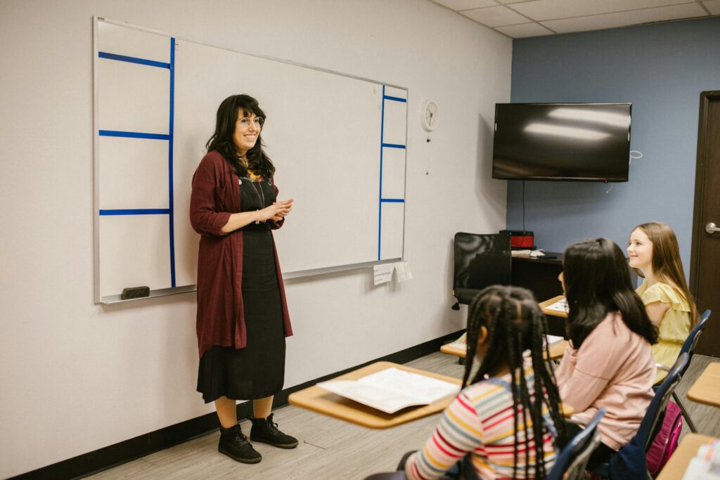 a woman presenting in front of a white board illustrating Body Language in Requirements Engineering