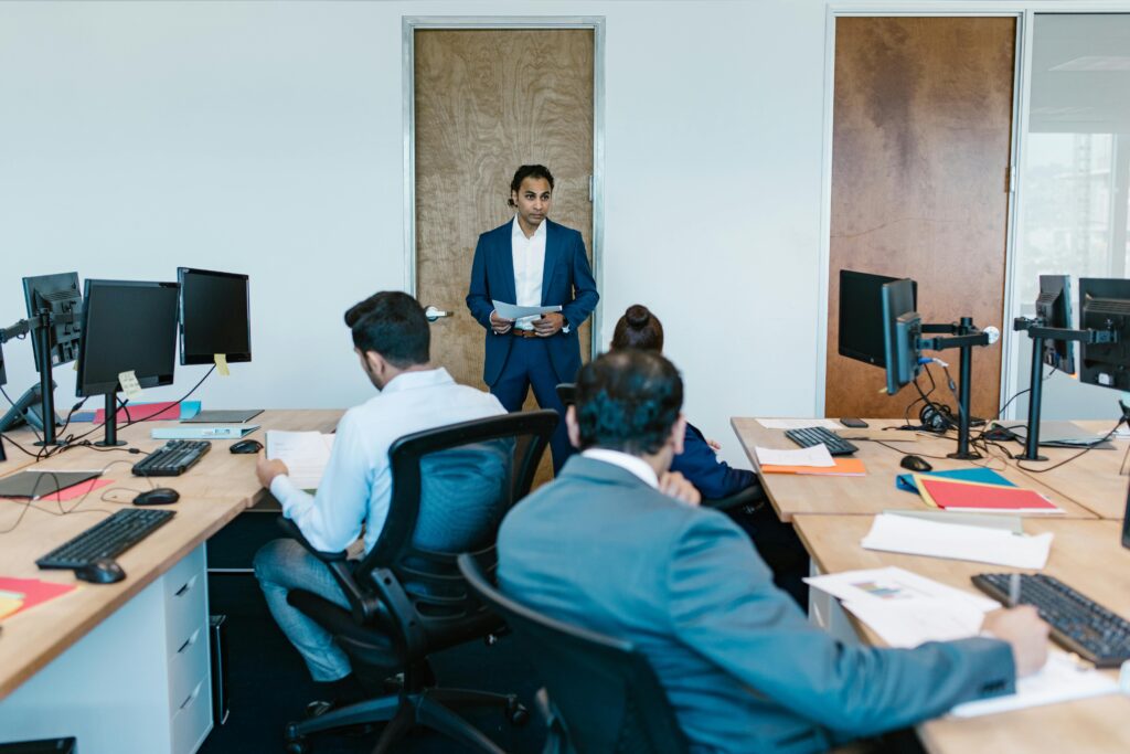 a man in front of managers illustrating Erikson's Epigenetic Principle for Stakeholder Solutions