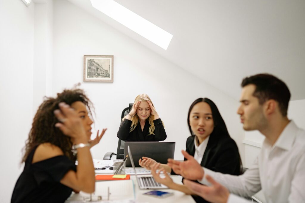 four business people arguing as an example for conflict resolution in the requirements process