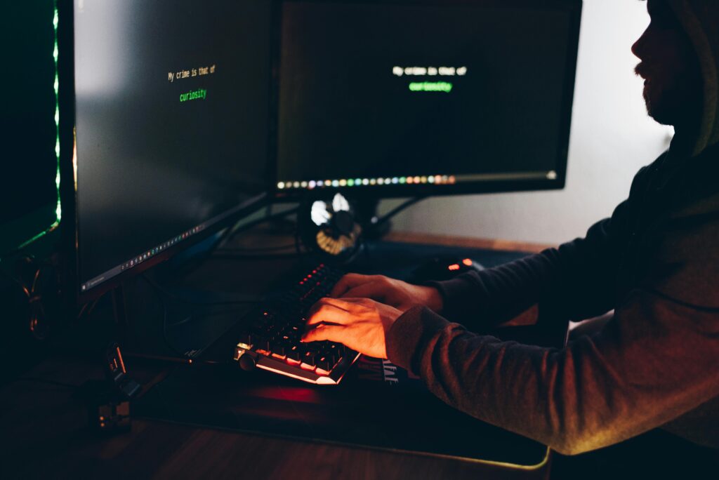 a programmer producing code on her laptop representing requirements determination from existing systems