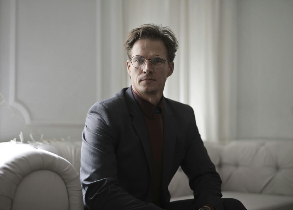 a man lookin seriously in the camera representing resolving conflicts between requirements