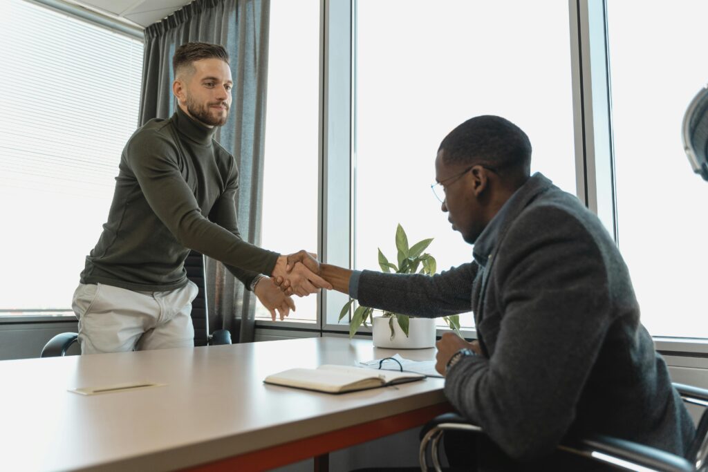 two men shaking hands illustrating change habits requirements engineering