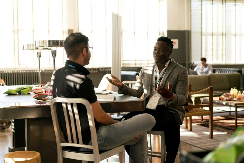 two business people sitting and negotiating illustrating Stakeholder Issues in Requirements Elicitation